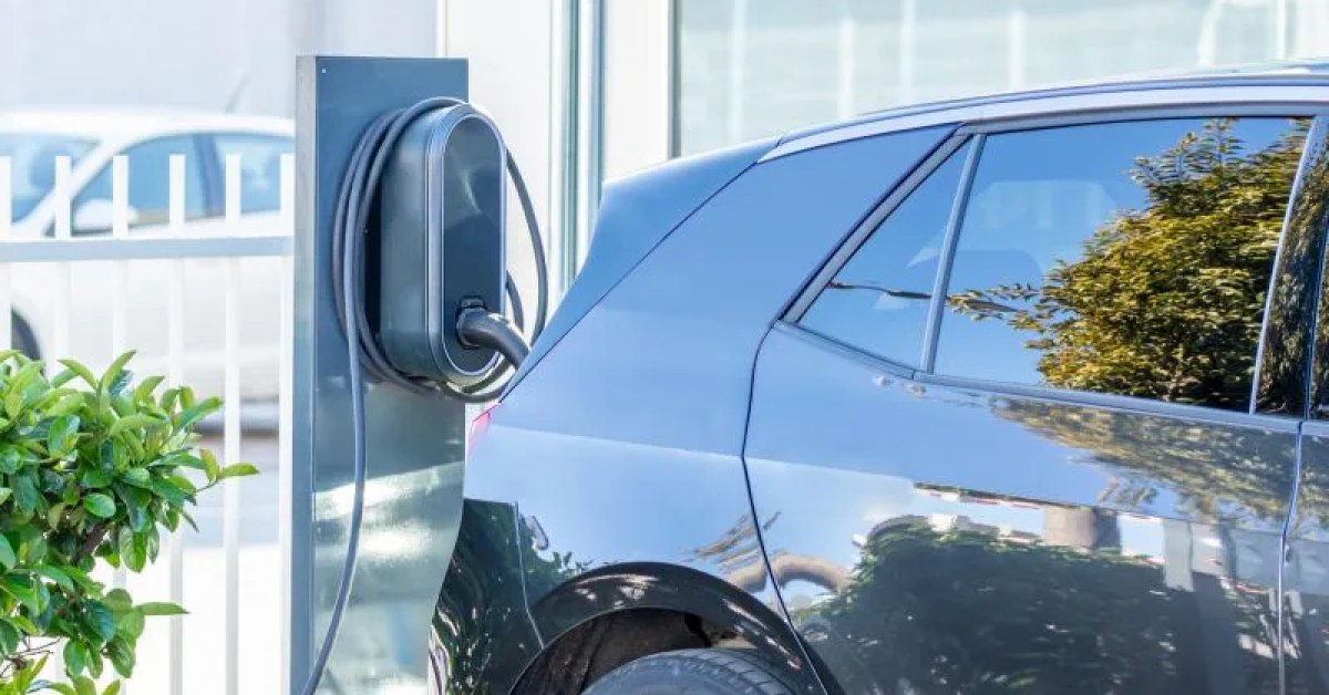 Home electric car charger being inspected for repair