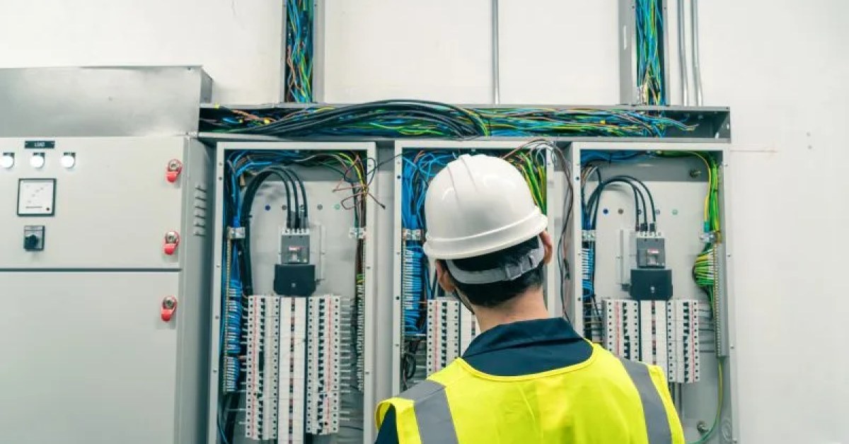 Electrician reviewing electrical work in a home
